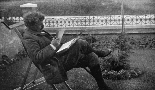 G.K. Chesterton lounging in a chair