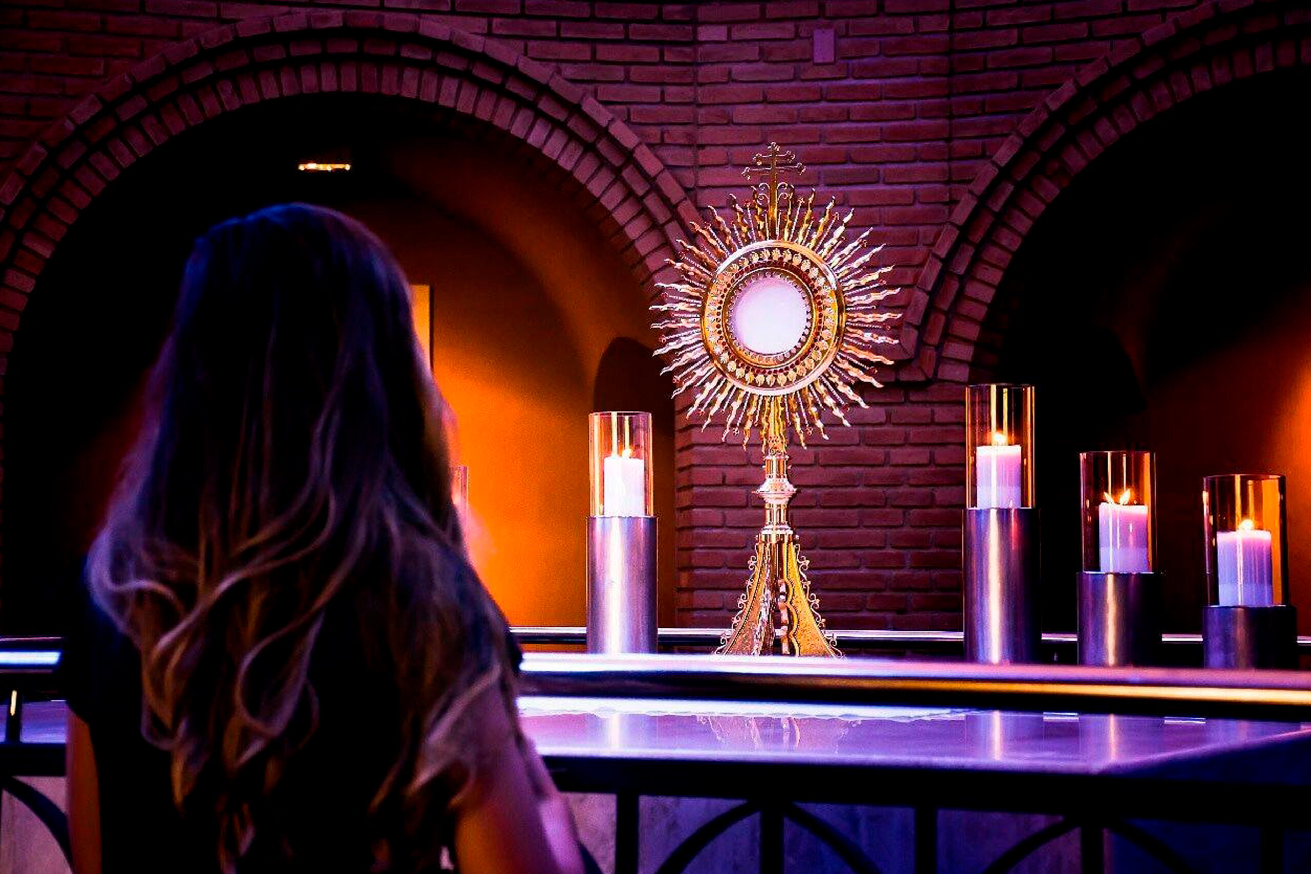 Girl looking at a monstrance
