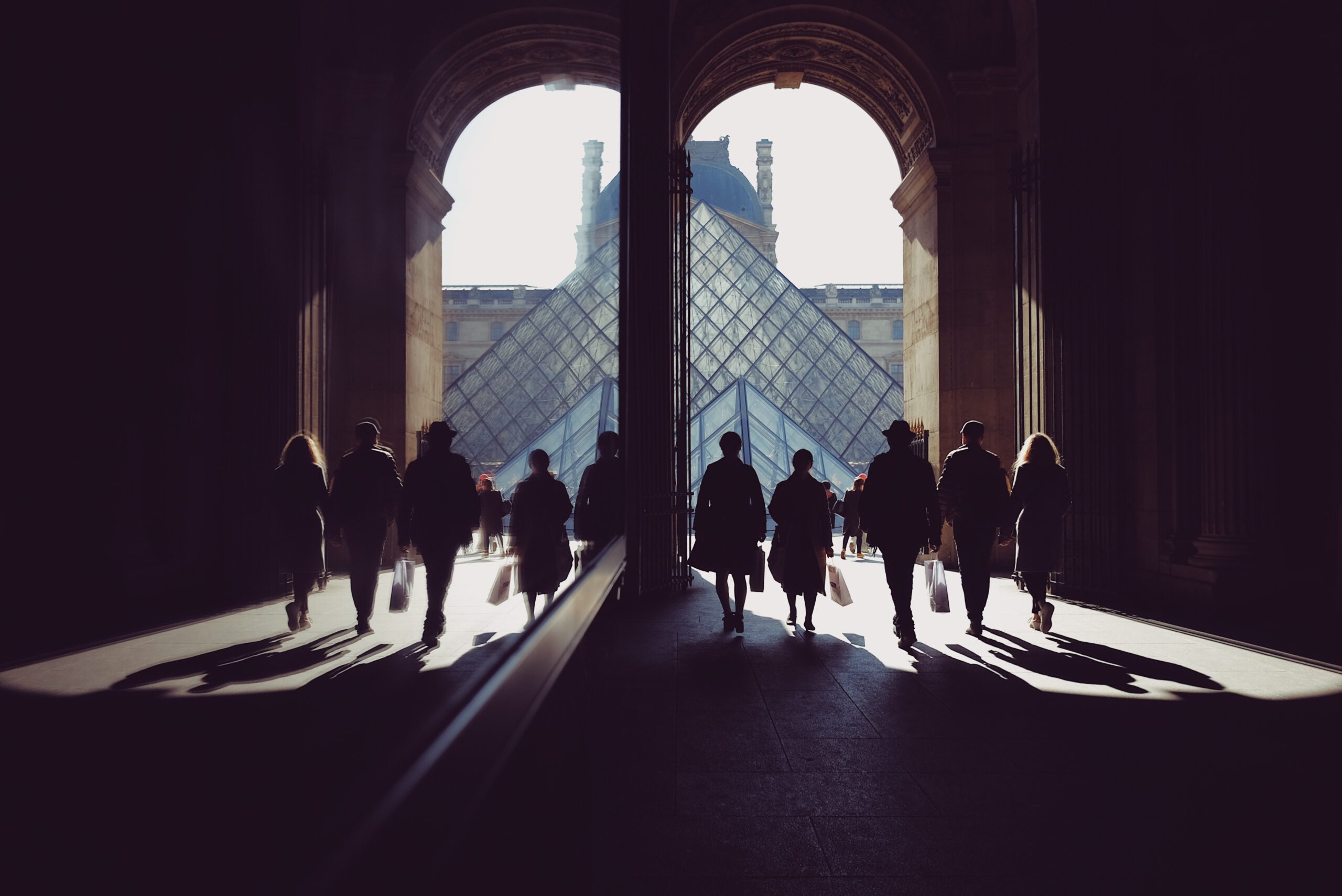 People walking with a strange architectural structure in the distance
