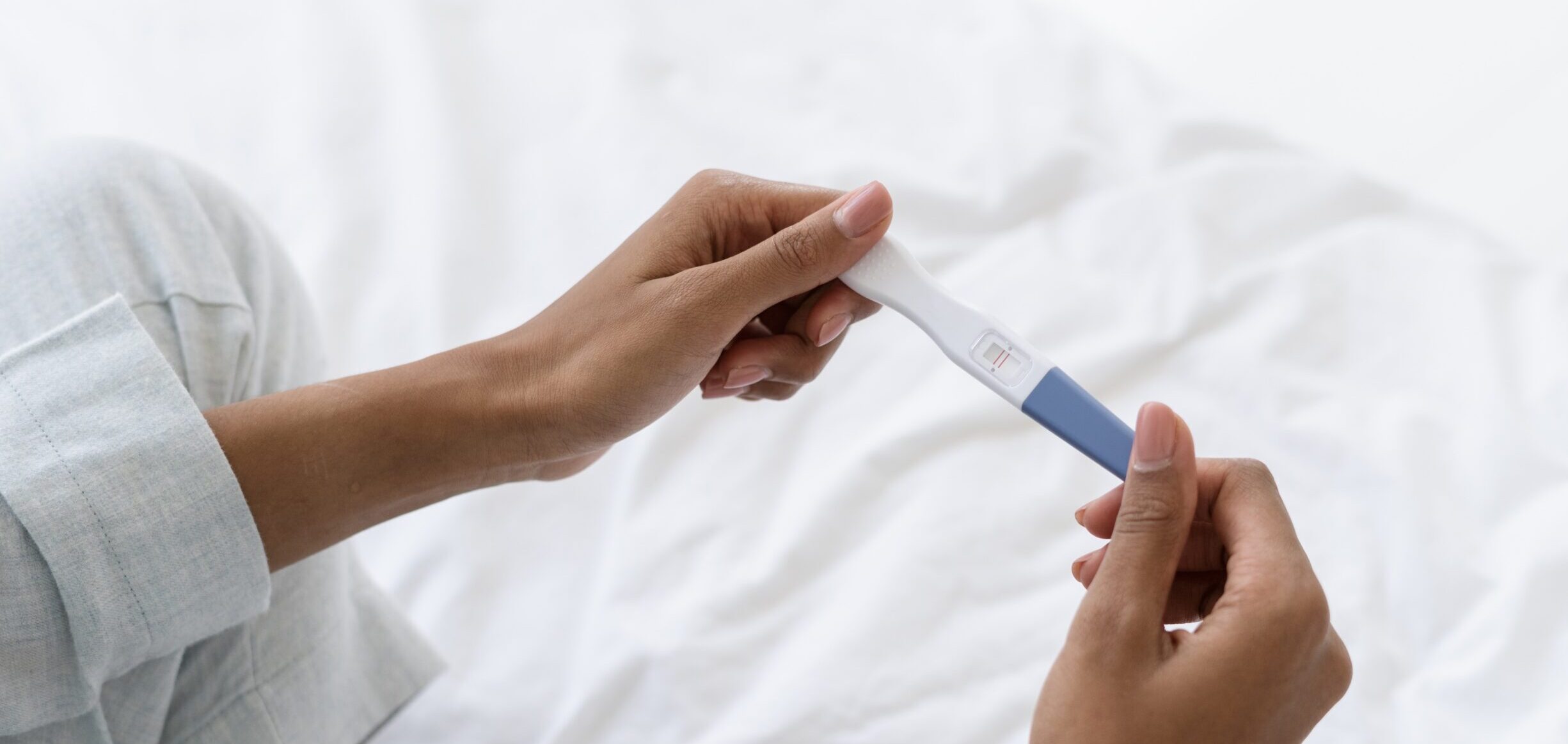 hands holding a pregnancy test