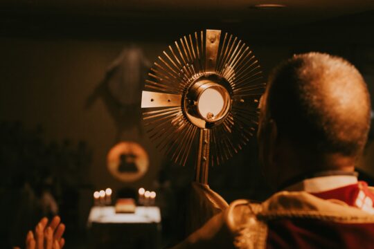 monstrance in front of priest