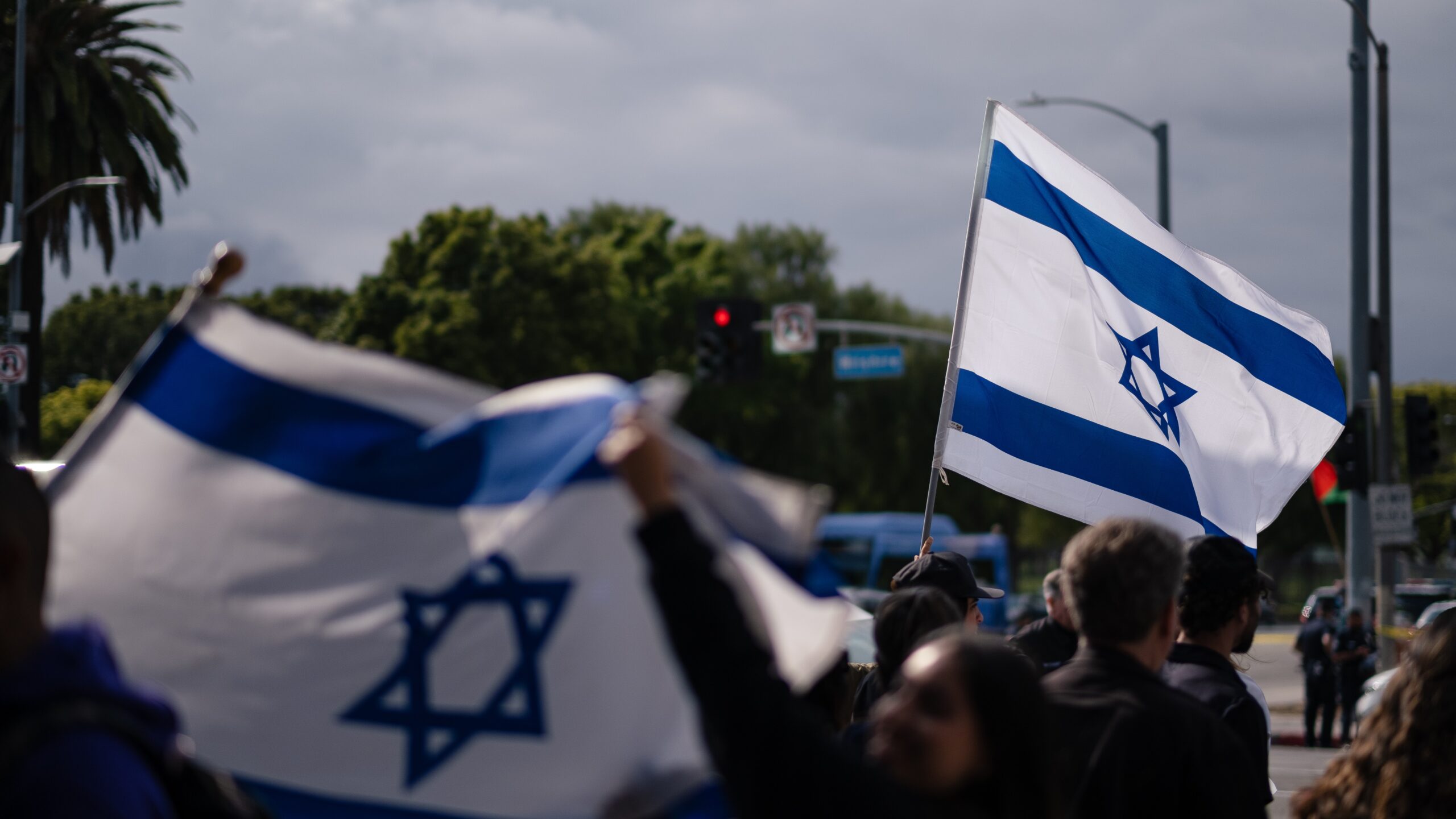 israeli flags waved in a crowd
