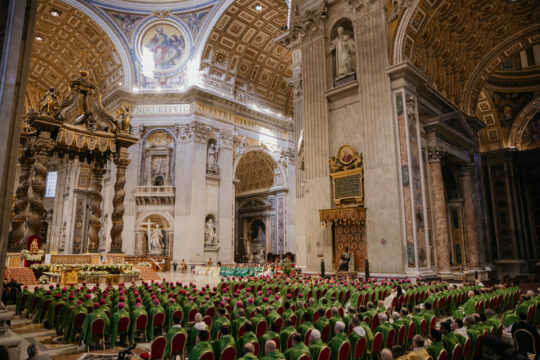 priests seated in big church