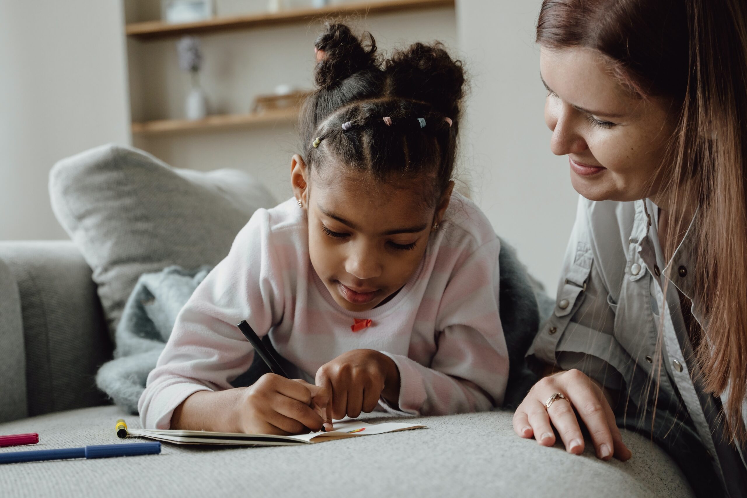 mom and child working at table together