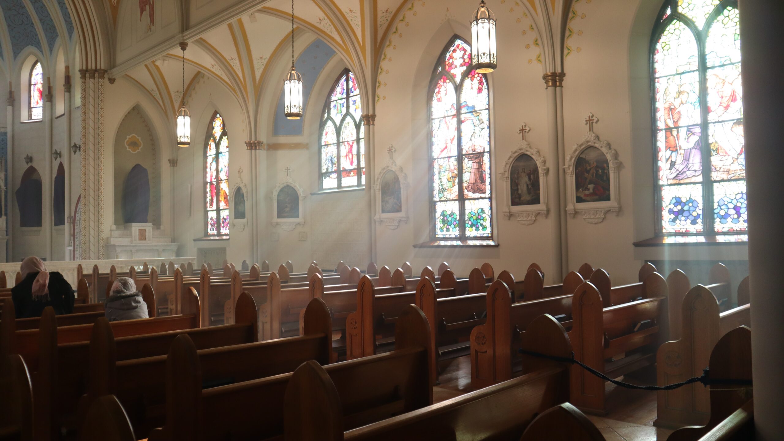 church pews and church with sun coming in windows
