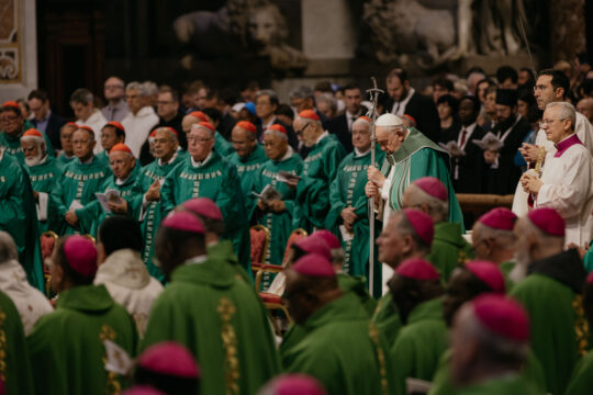 pope in green surrounded by clergy