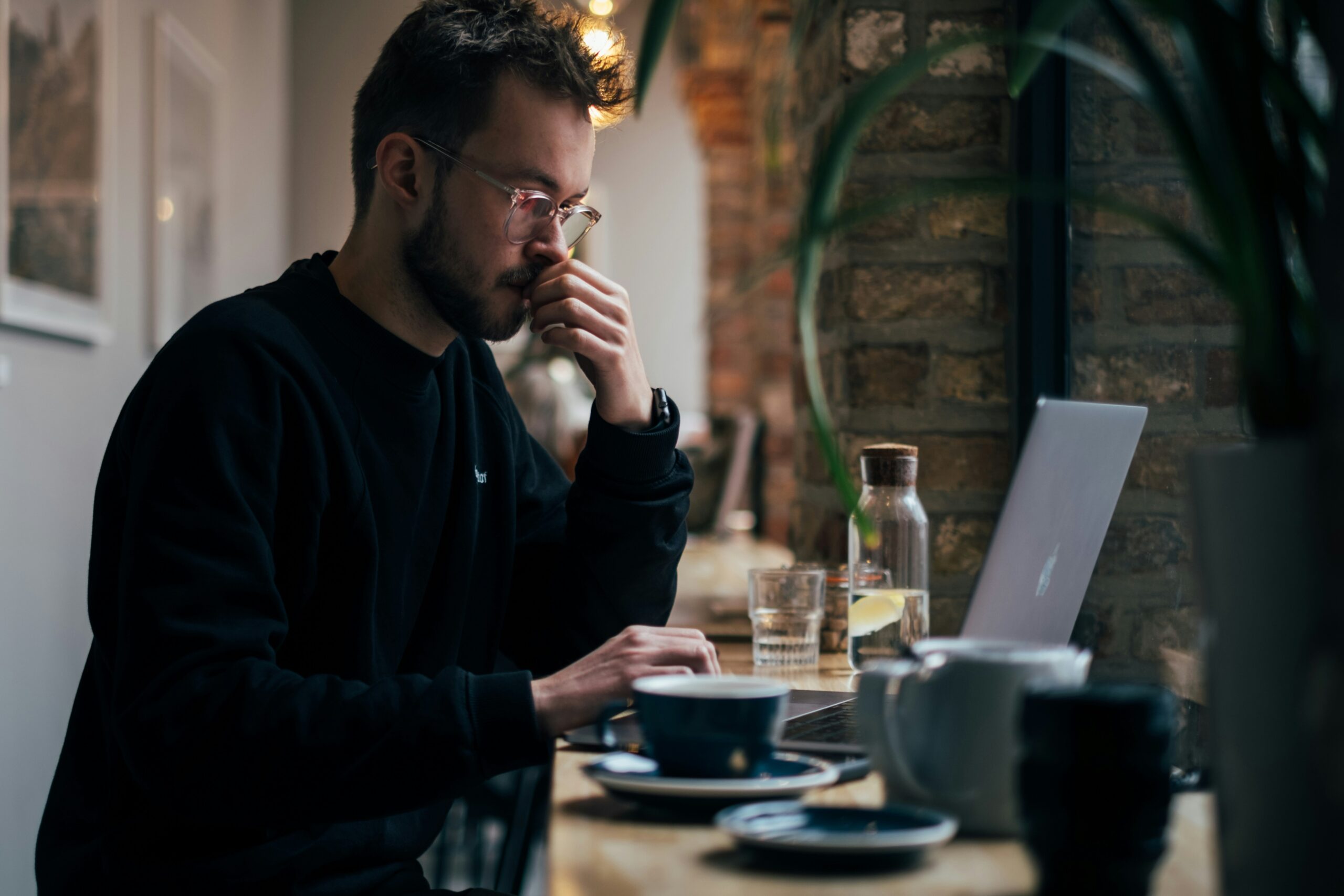 a man very pensive at his computer