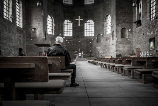 Man sitting in an empty church