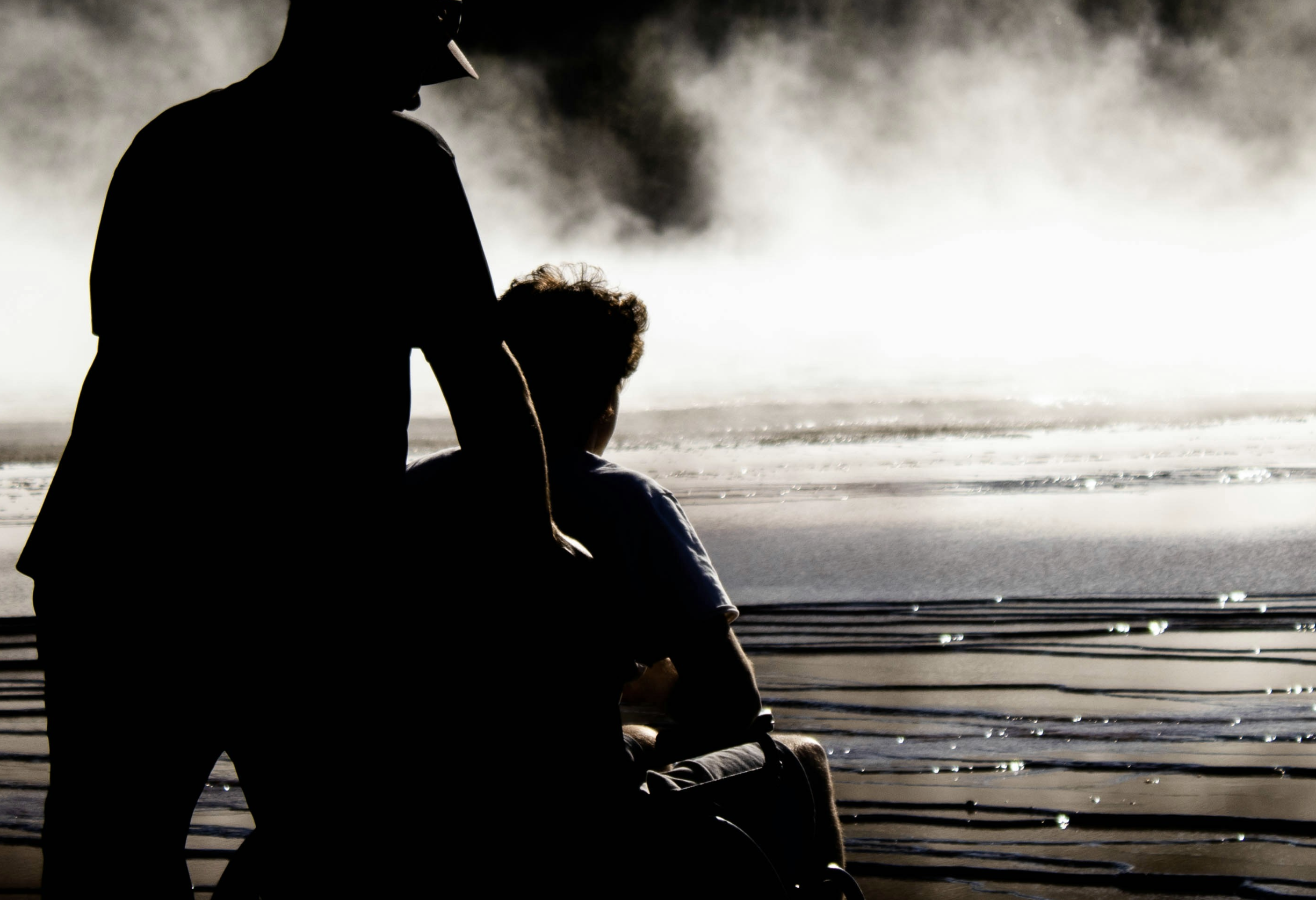 Man pushing a boy in a wheelchair