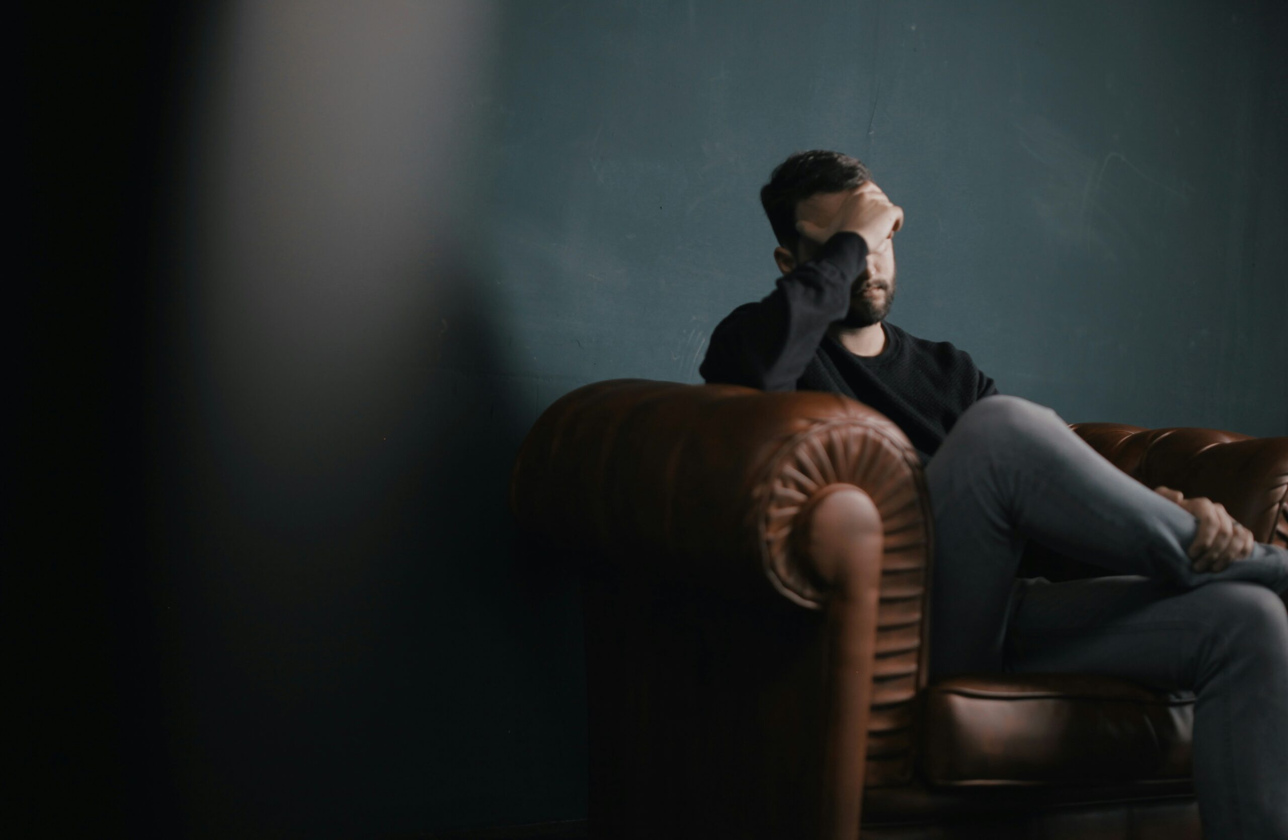 Man sitting and looking ashamed
