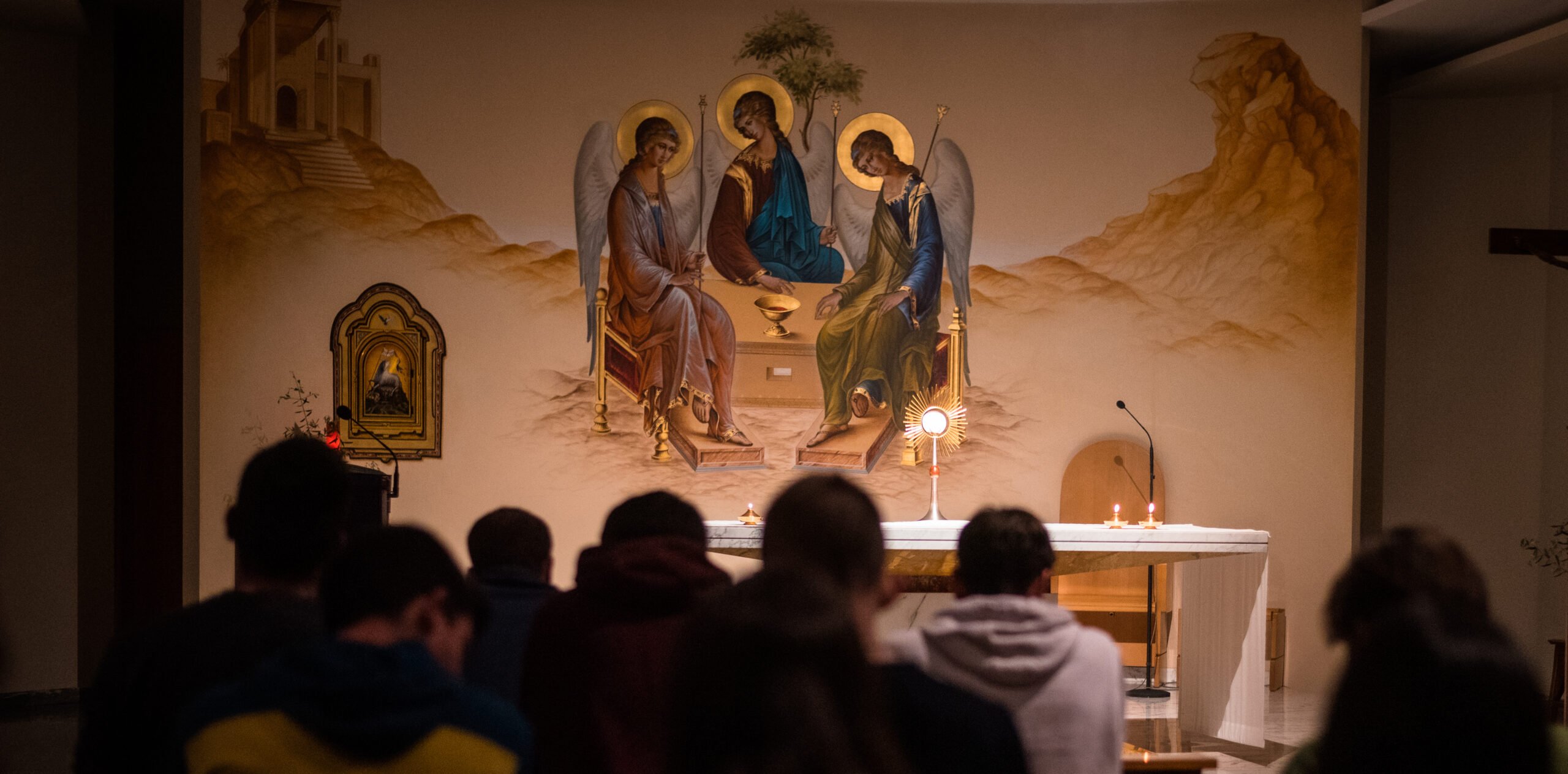 People praying in front of an altar