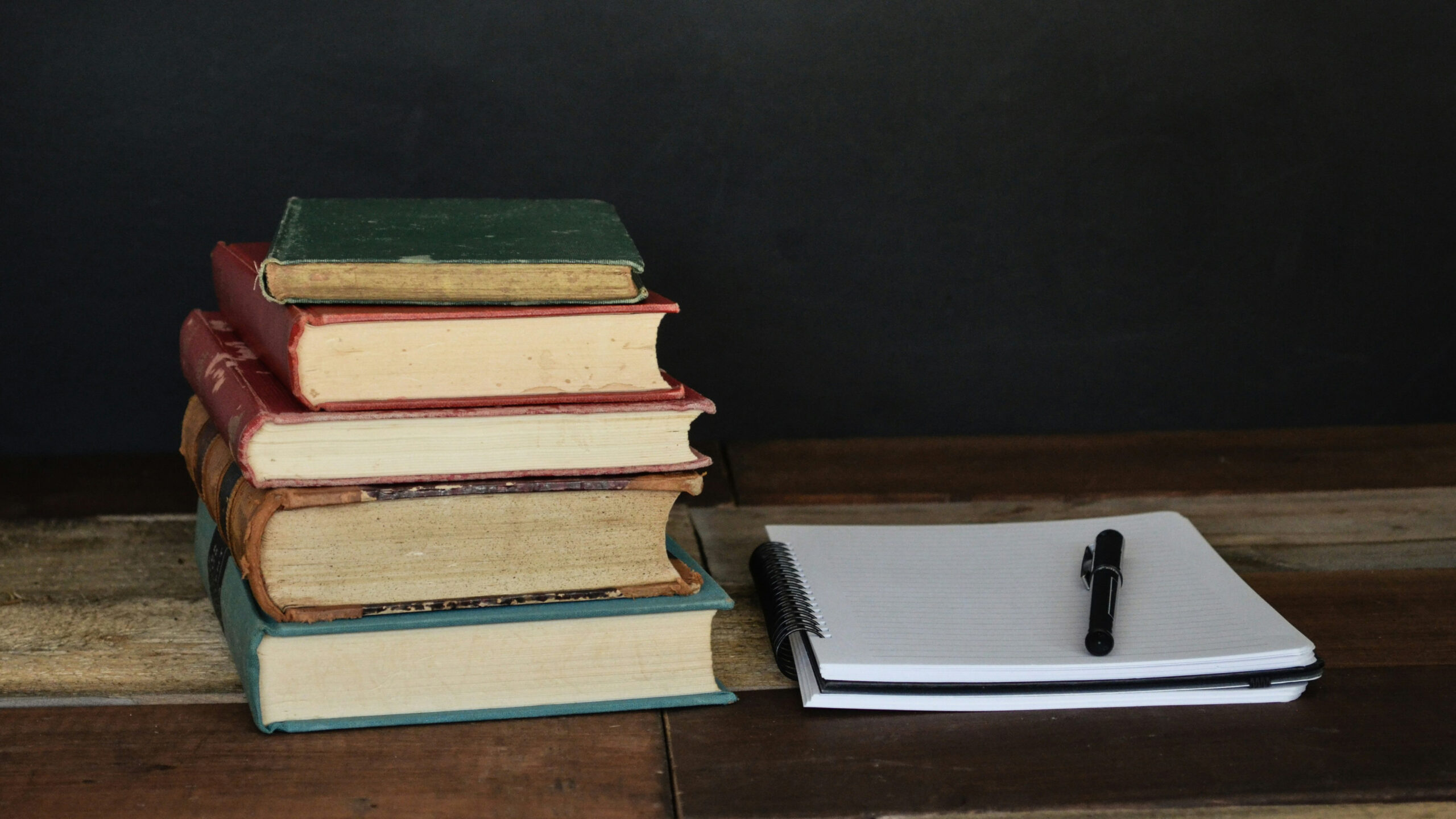 stacks of books and a notebook