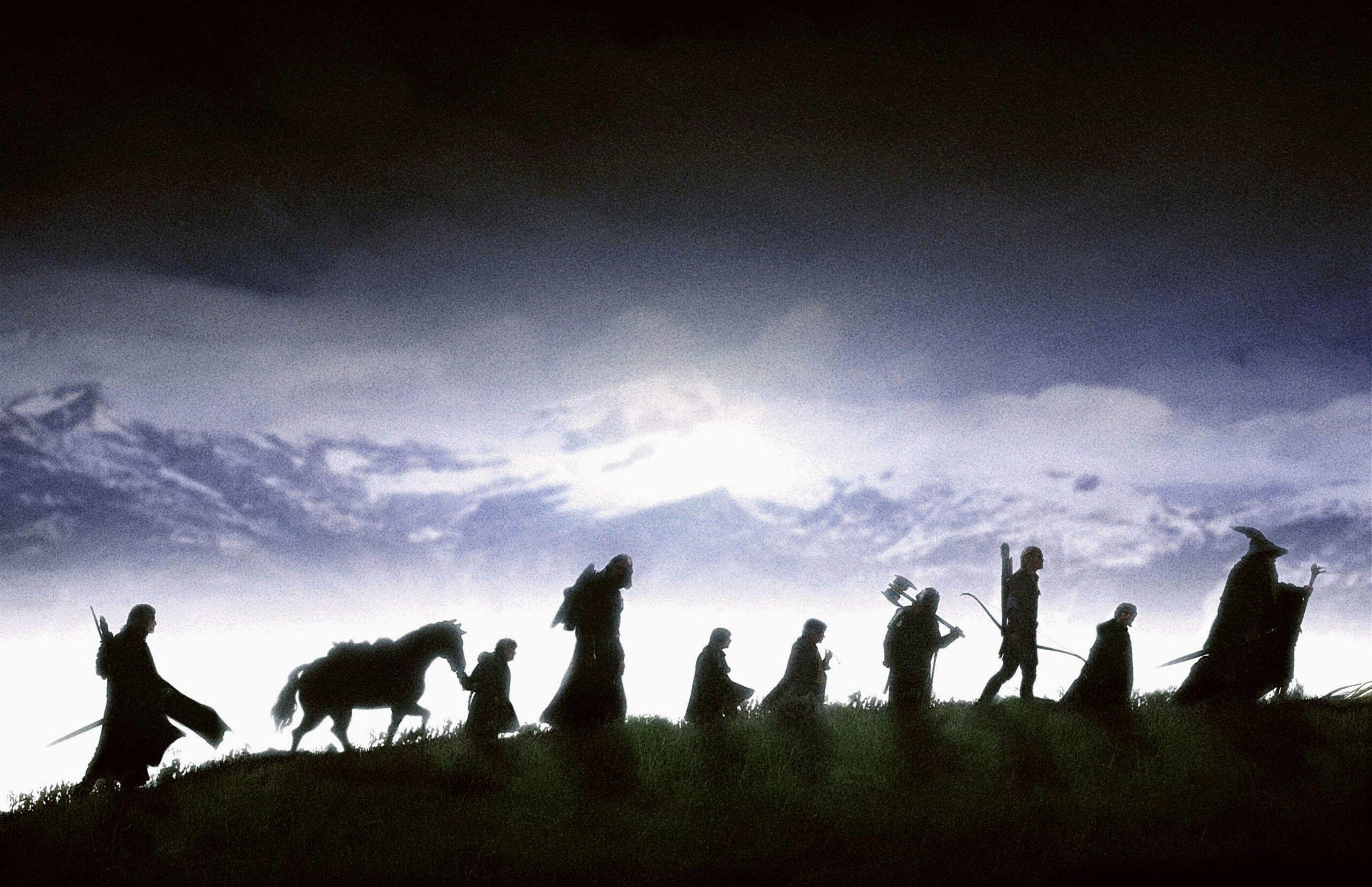 Silhouette of the members of the Fellowship of the Ring walking