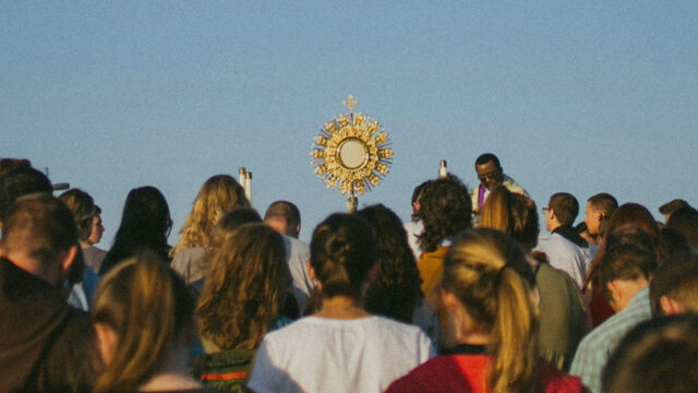 People gathering around a monstrance