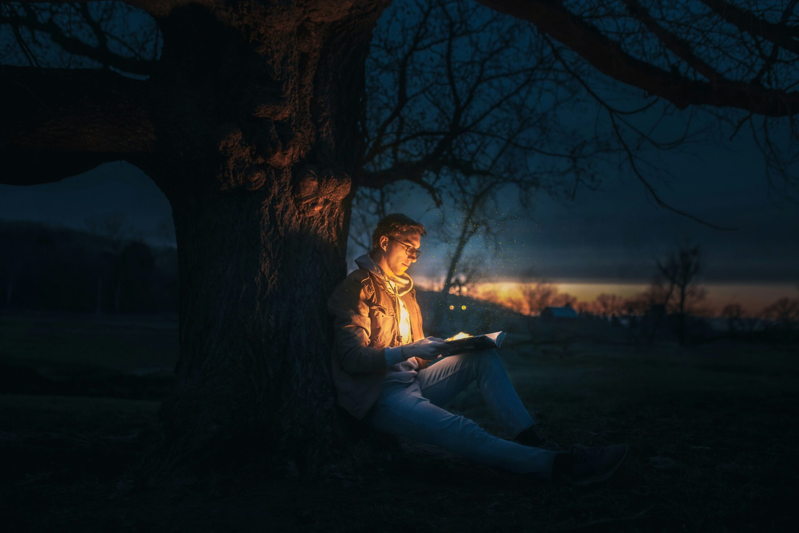 Man reading under a tree