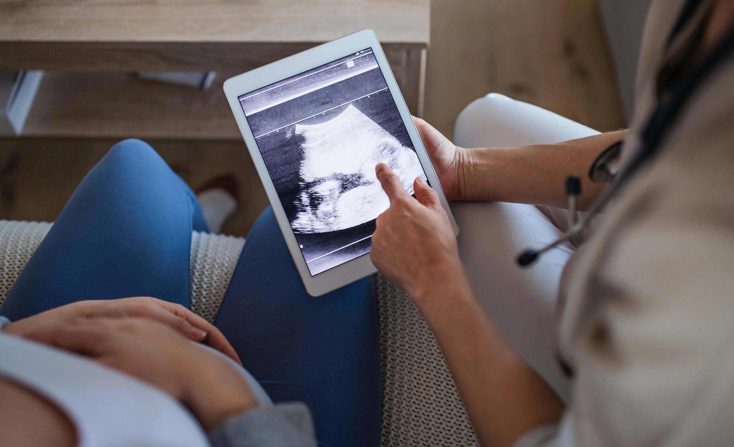 couple looking at an ultrasound image on an ipad