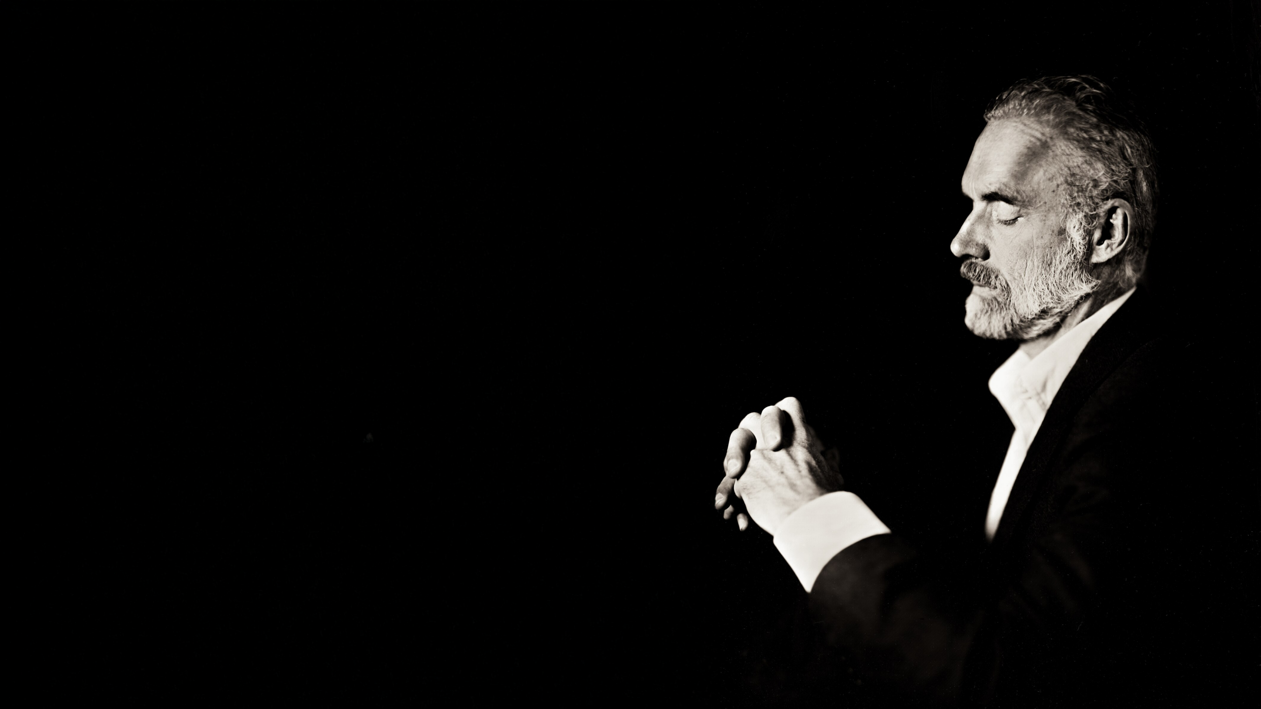 Jordan Peterson sitting and looking pensive