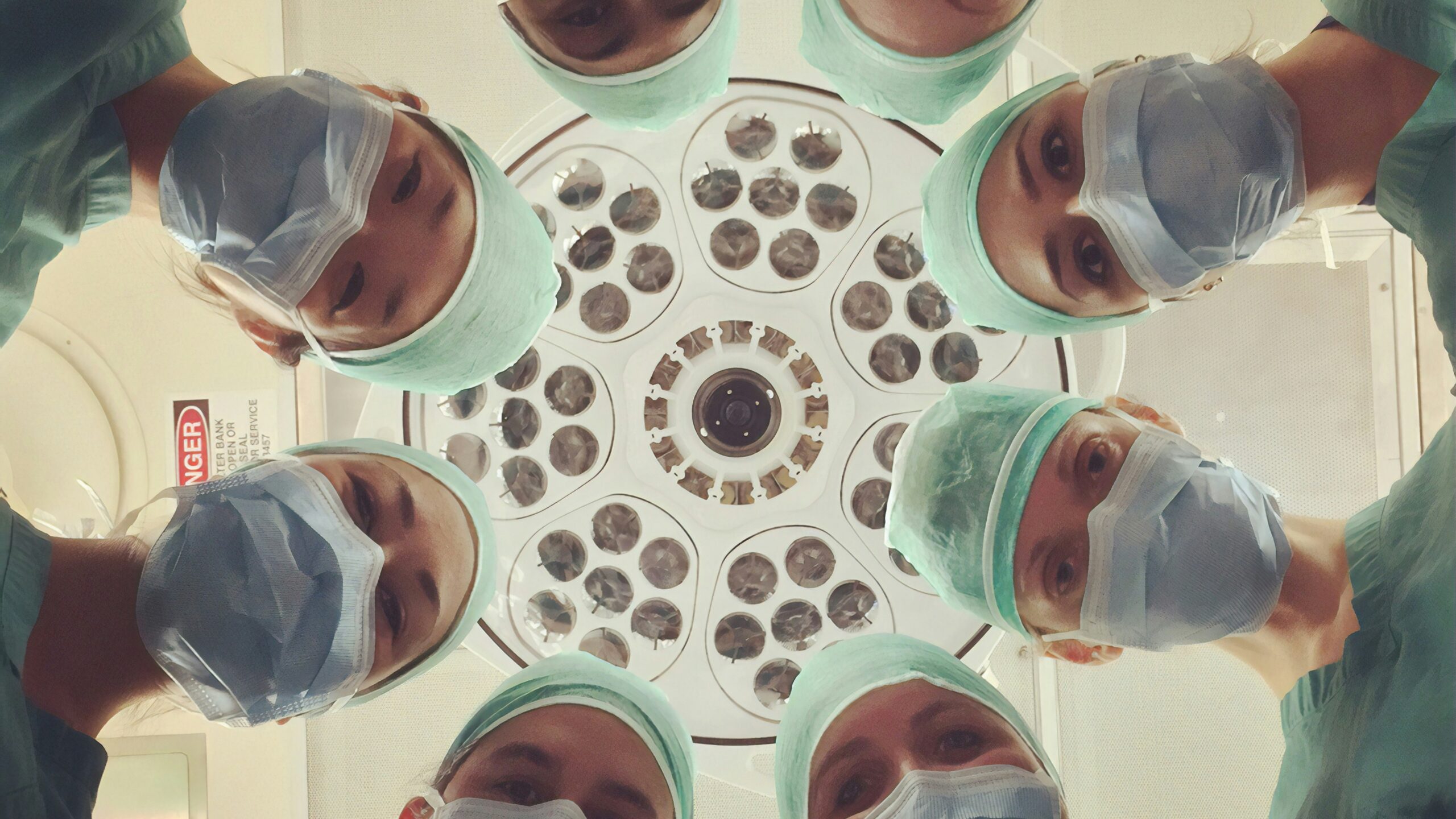 view of doctors looking down toward a patient