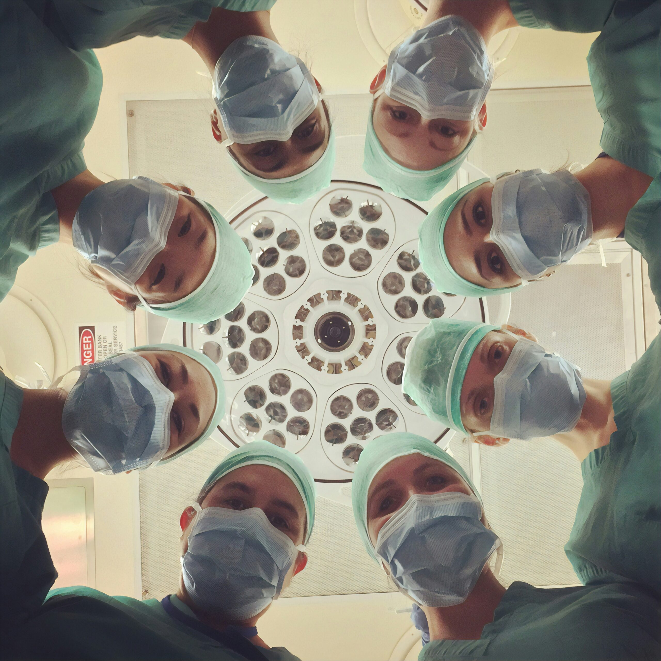 view of doctors looking down toward a patient