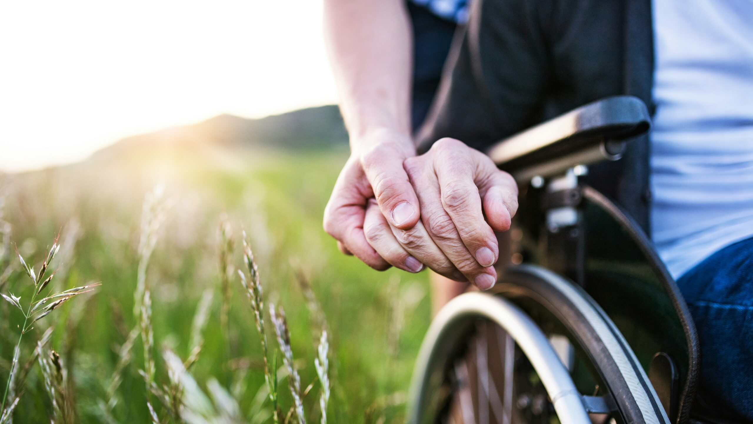 hands together holding a wheelchair