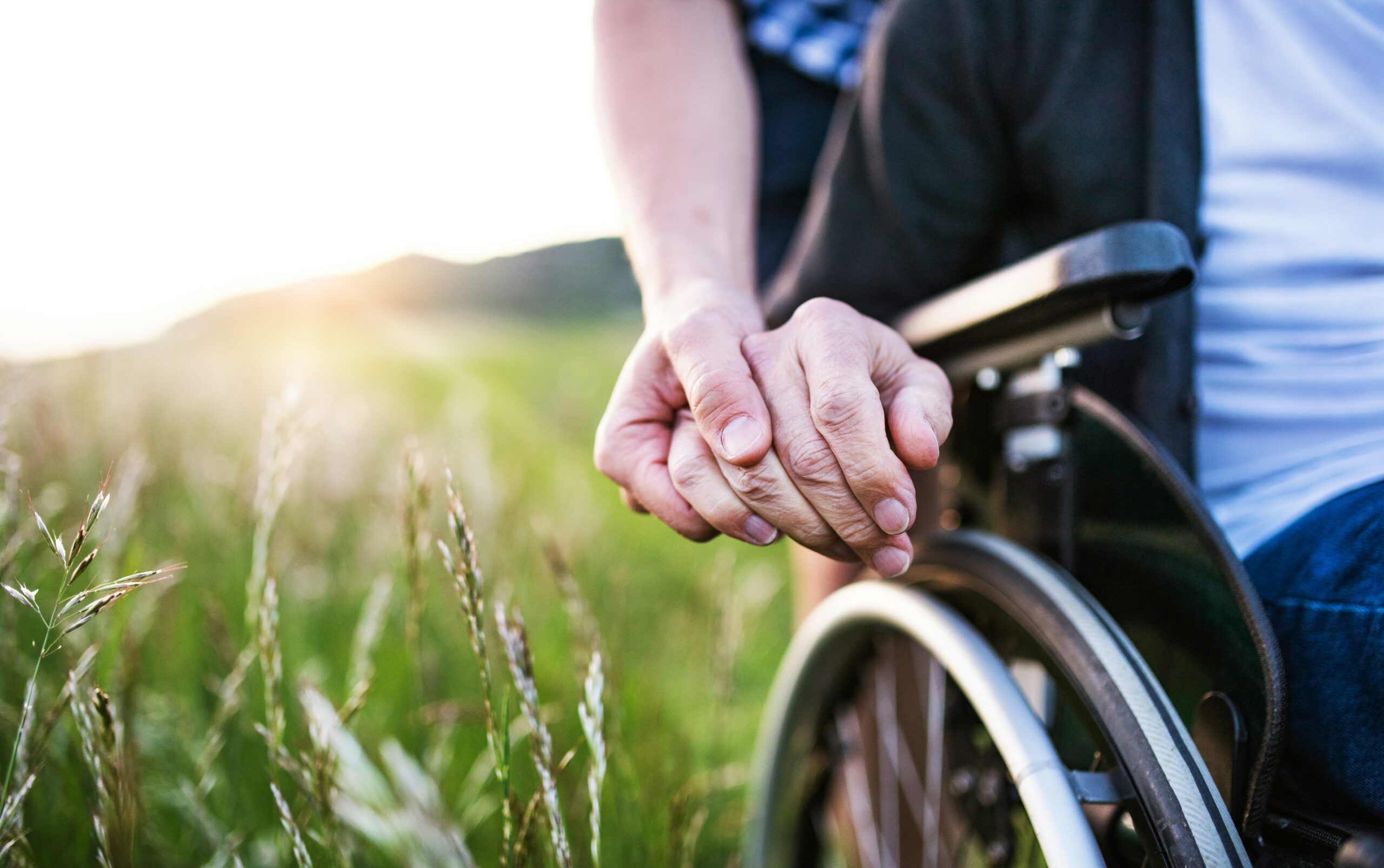 hands together holding a wheelchair