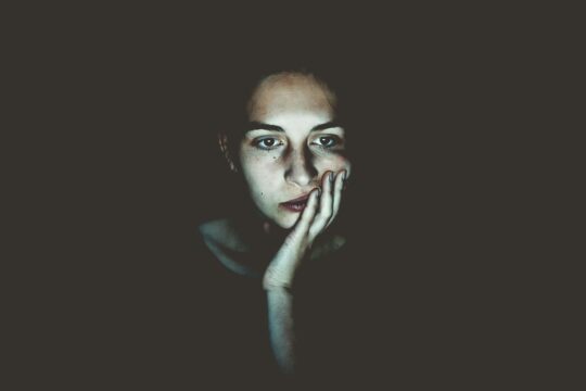 girl looking bored and staring at a screen