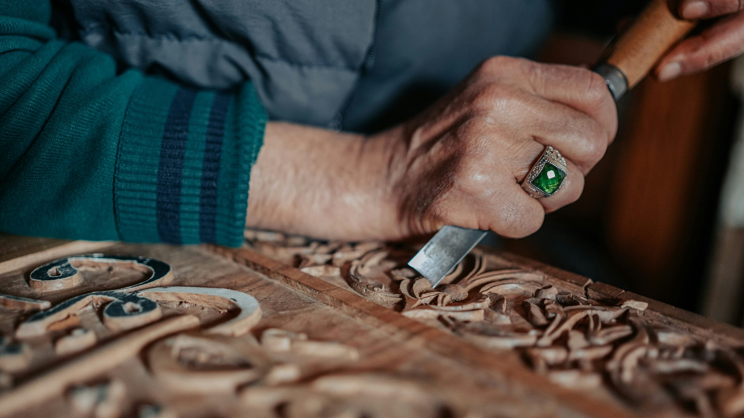 hands working on wood design