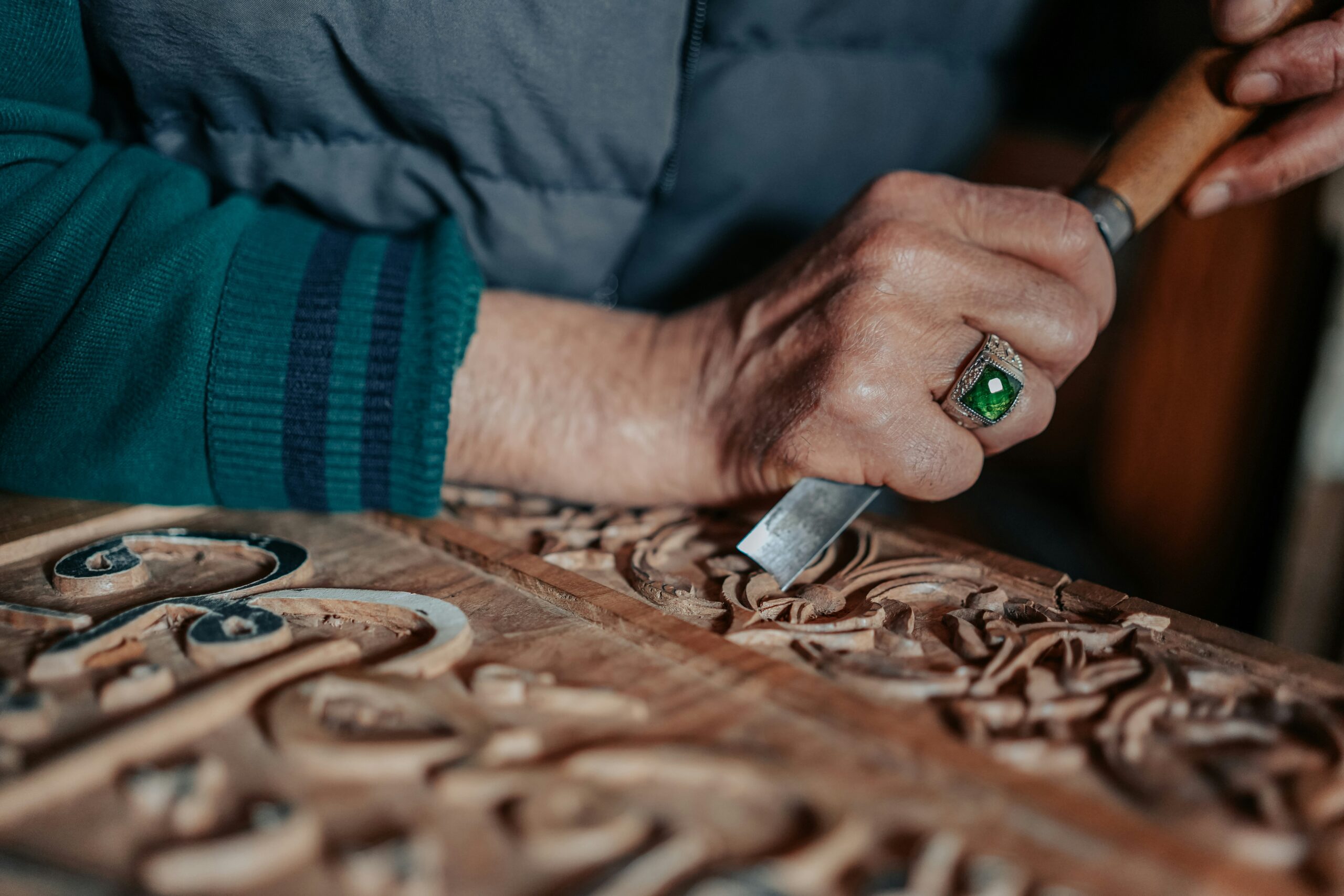 hands working on wood design