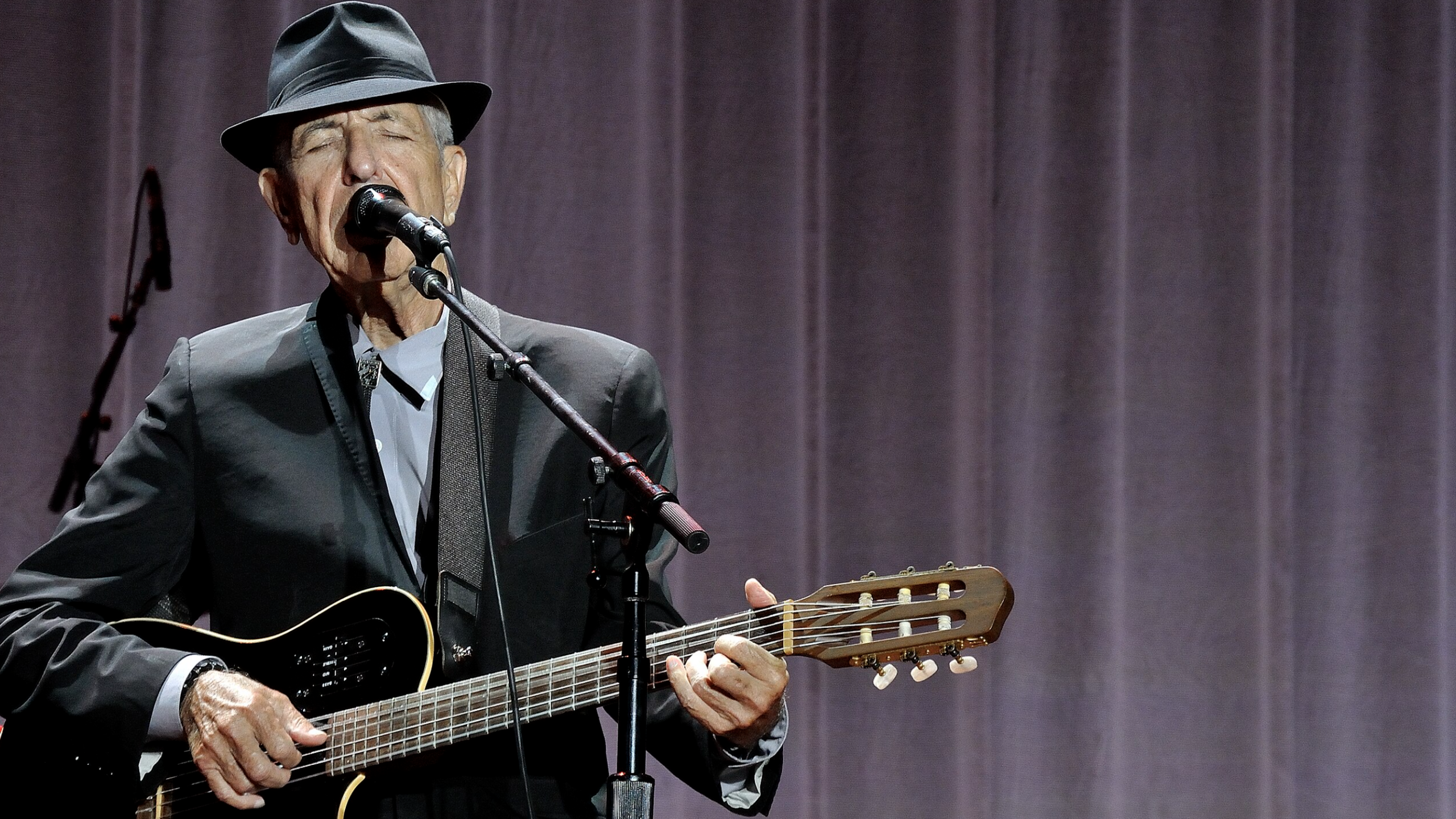 Leonard Cohen performing on stage