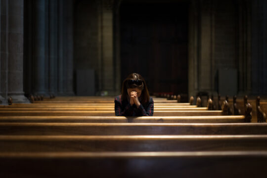 praying in a pew