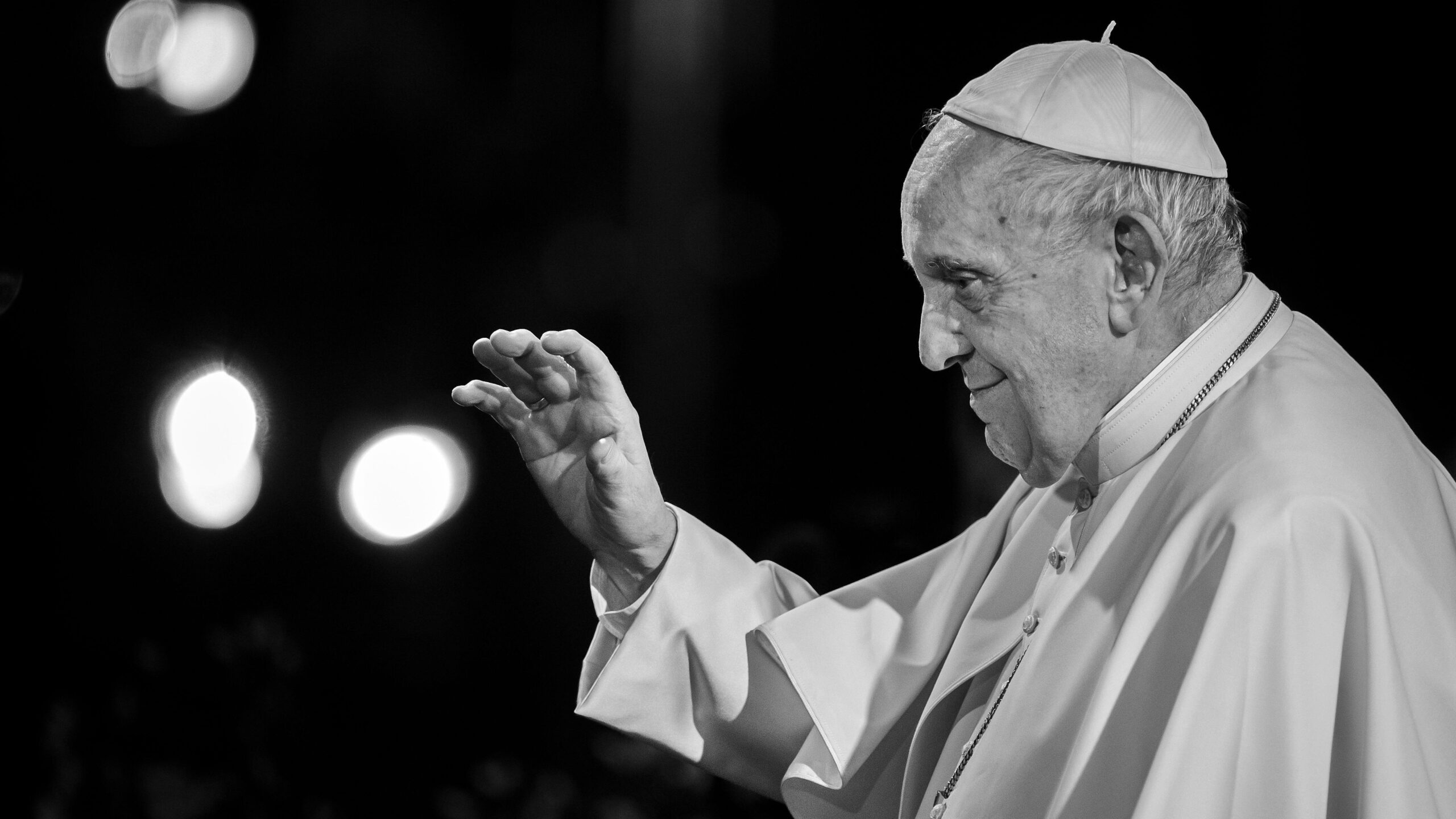 Pope Francis with his hand raised