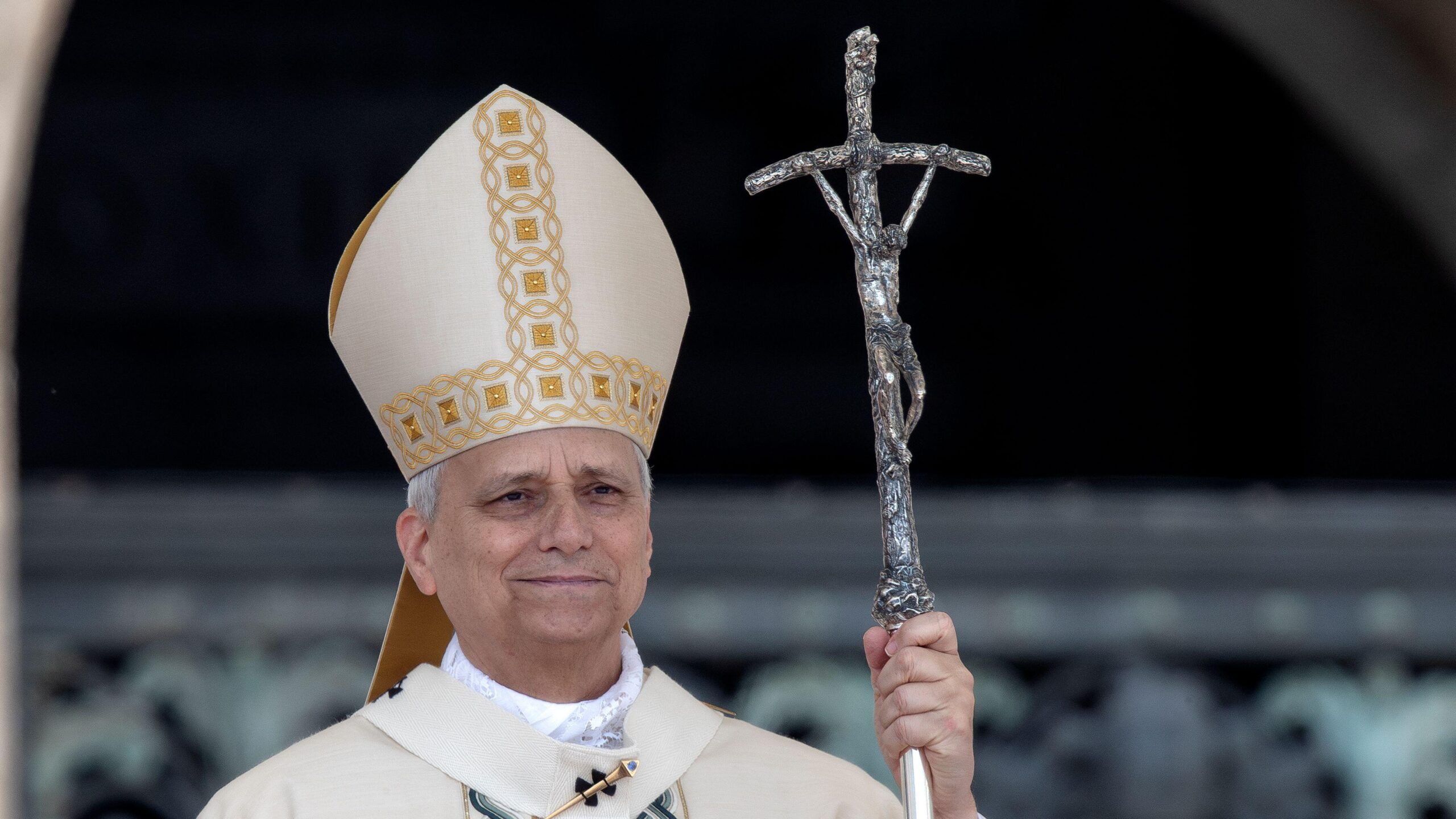 Pope Leo XIV standing with a cross