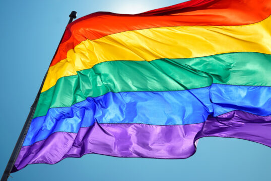 Rainbow flag on clear sky