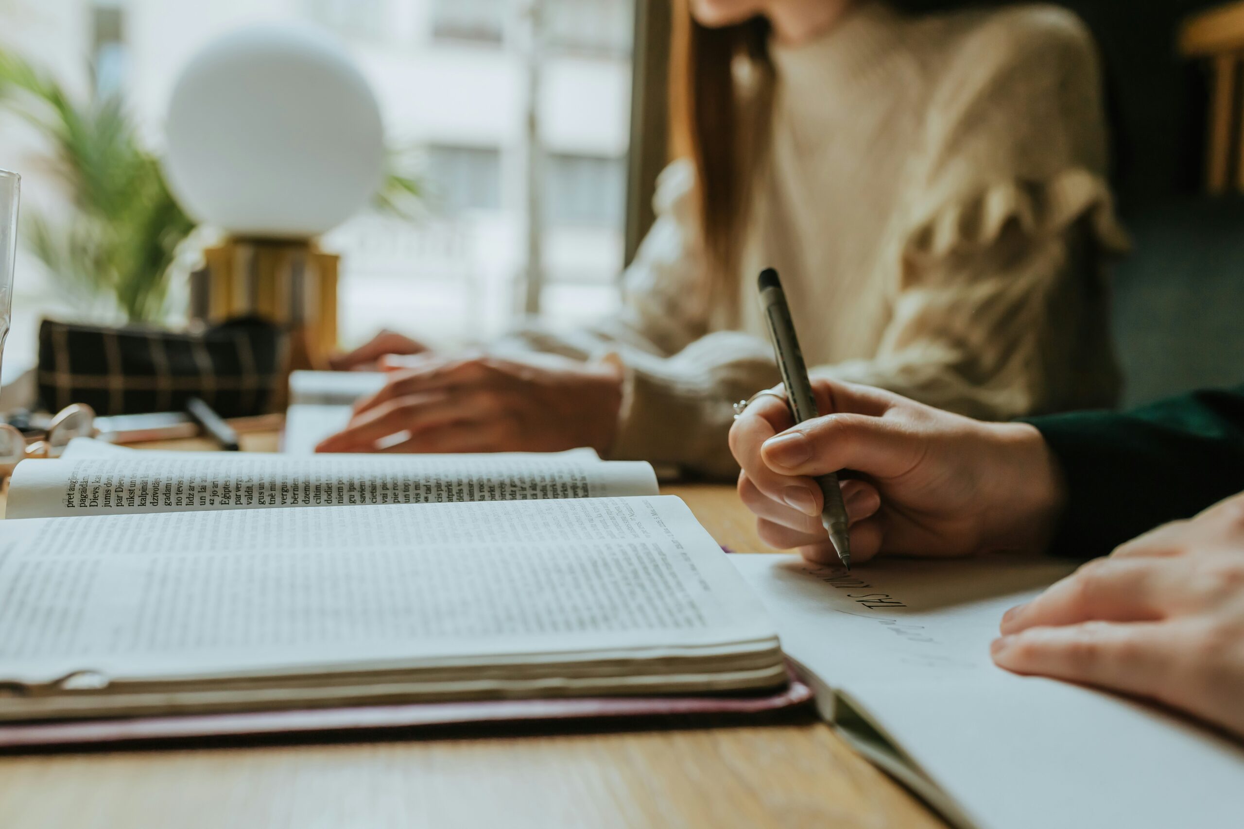 people writing at a desk