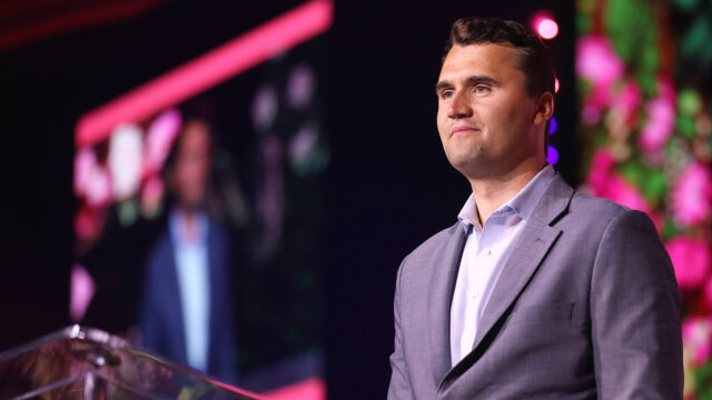 Charlie Kirk standing and smiling