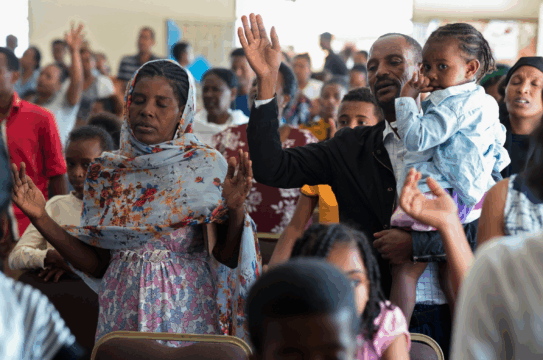A Crowd of People Praying