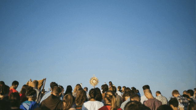 crowd of pilgrims with eucharist