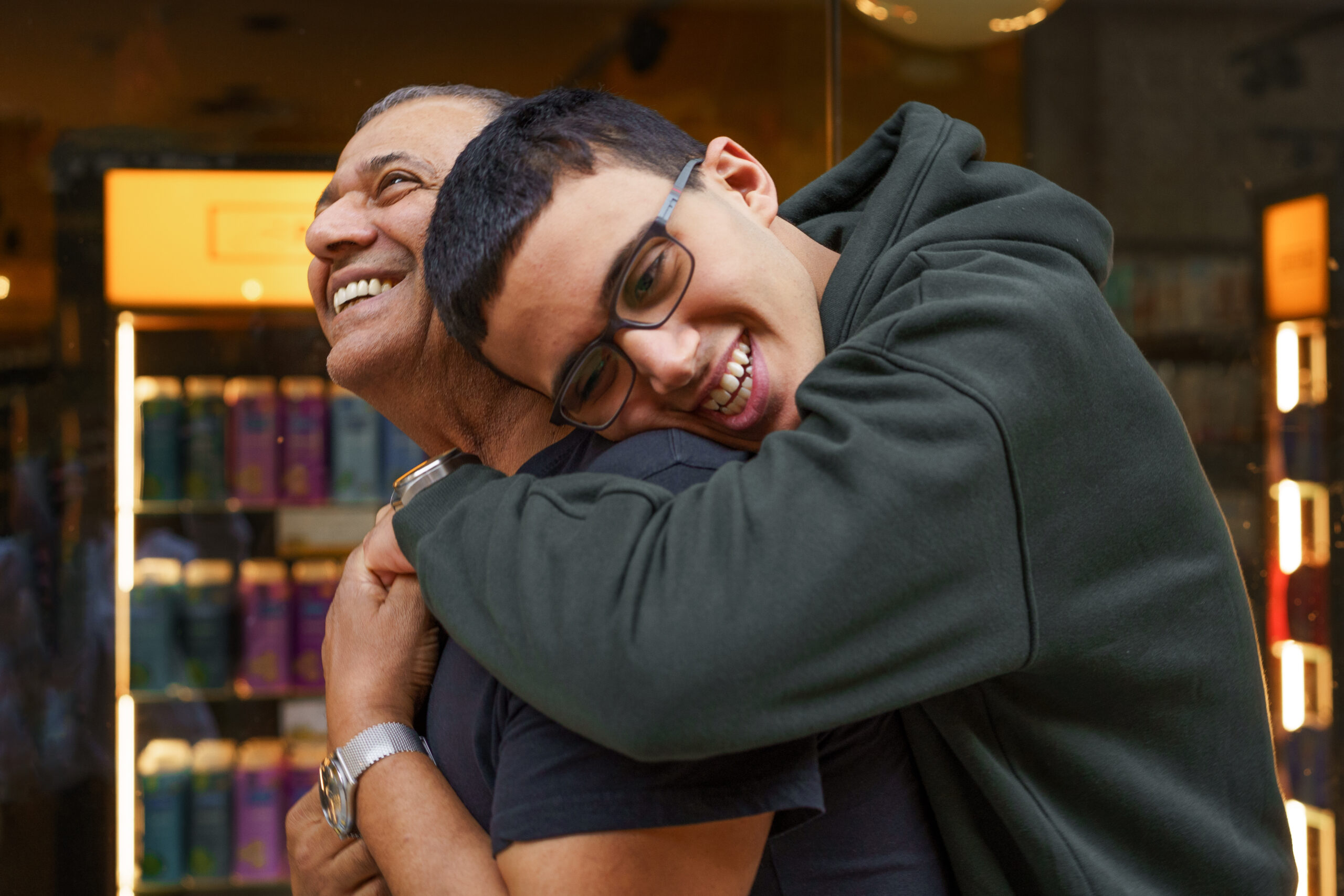 Senior Father And Son Hugging On The Mall.