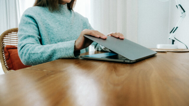 girl in sweater with laptop
