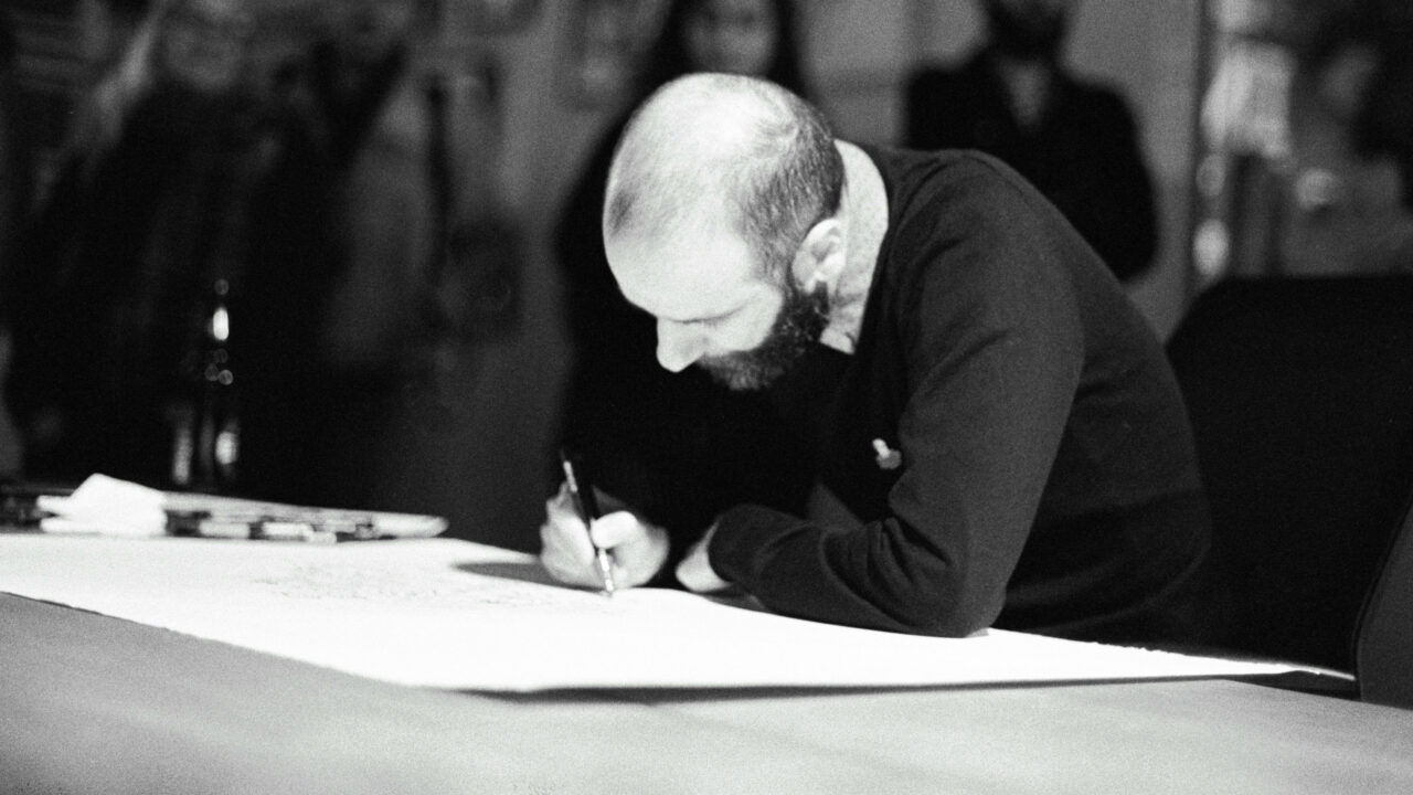 black and white man writing