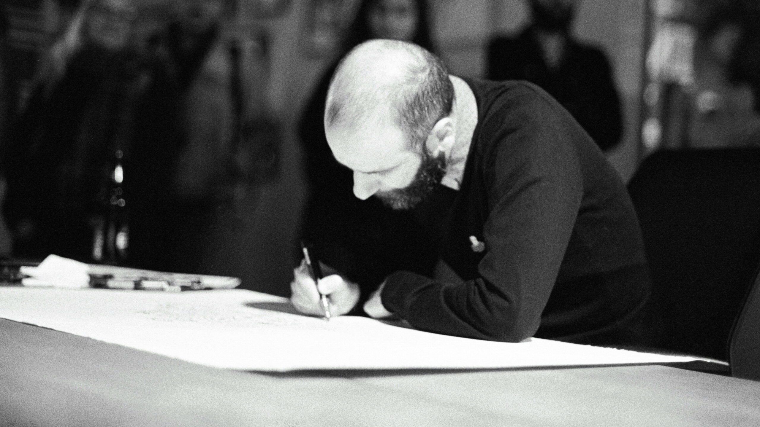black and white man writing
