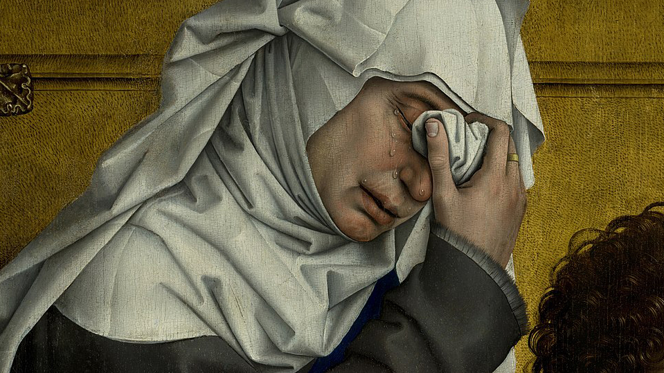 woman with white veil wiping face