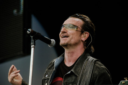 man singing in front of microphone