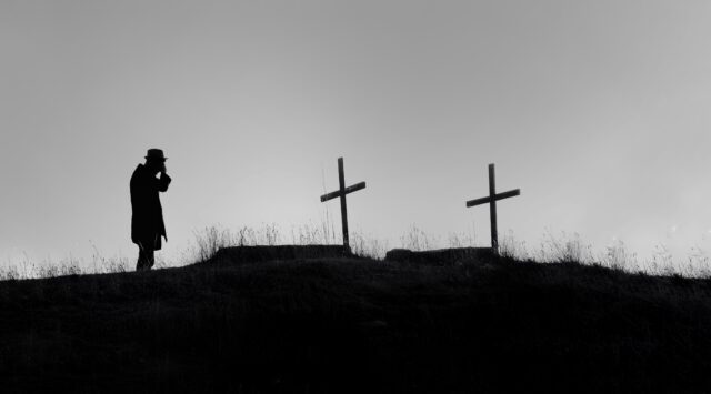 figure backlight overlooking crosses