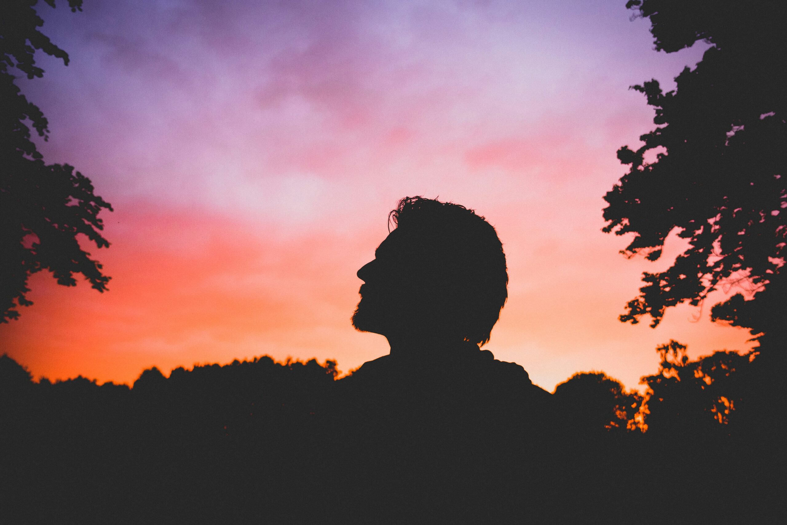 man looking at sunset