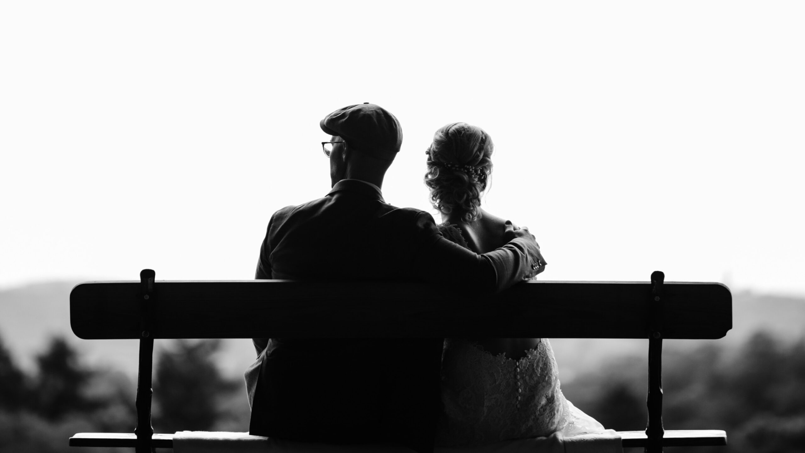 man and woman sitting together on a bench