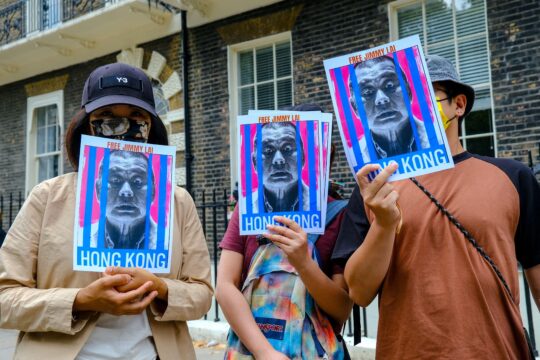 People holding signs in support of Jimmy Lai