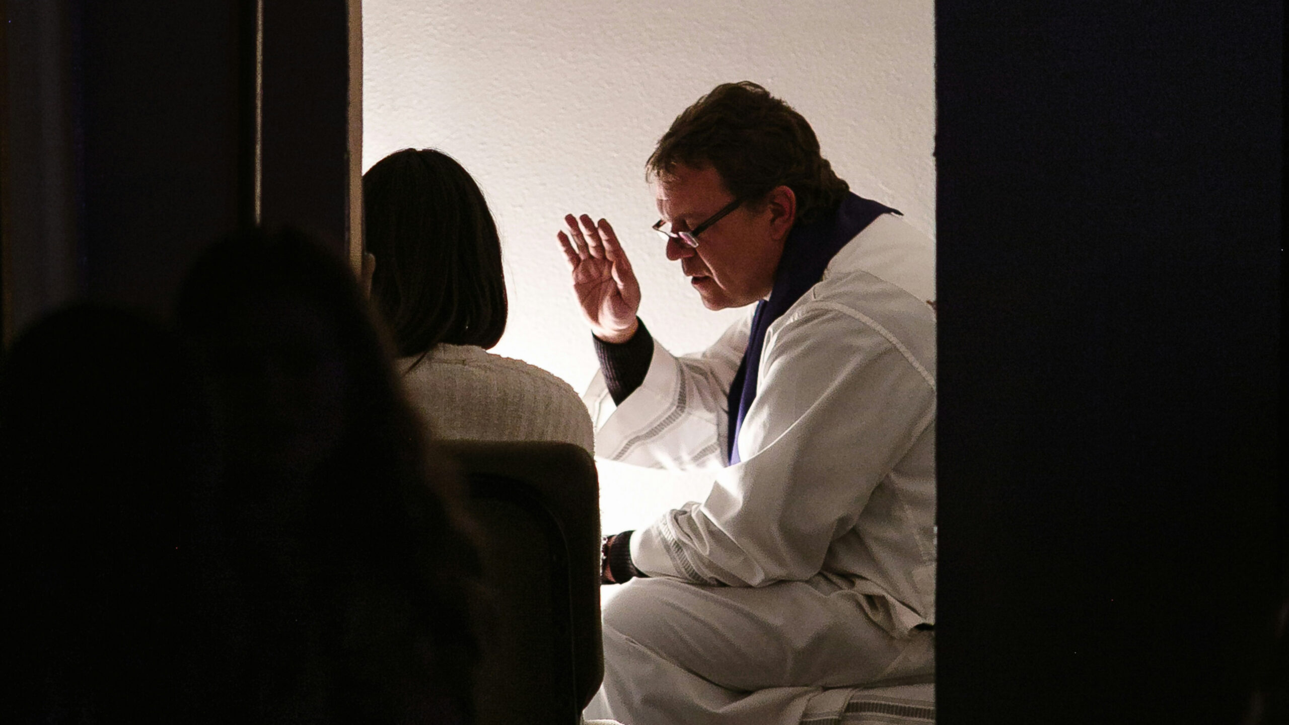 a priest blessing someone