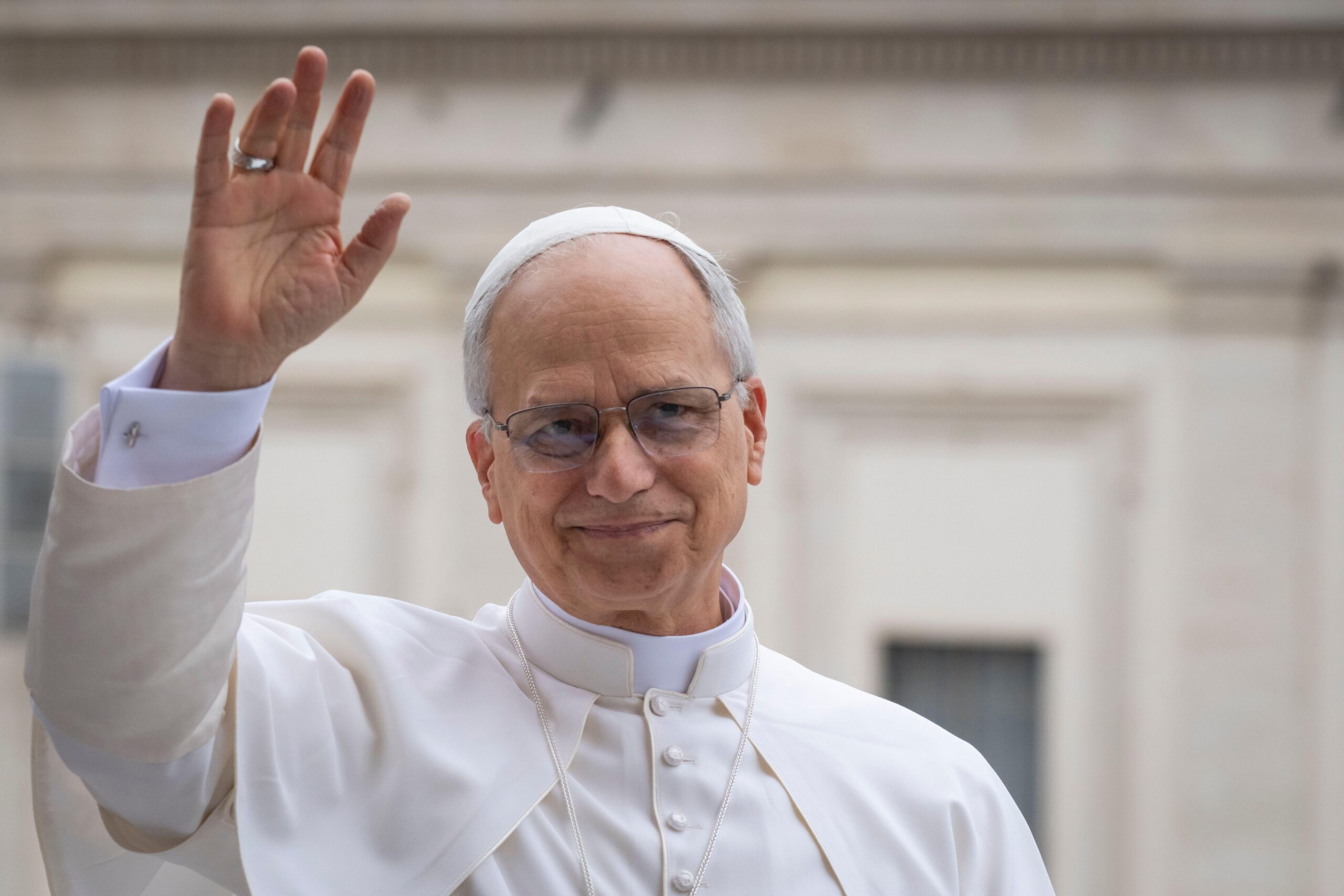 Pope Leo XIV waves to the crowd during the weekly general audience at St Peter's Square